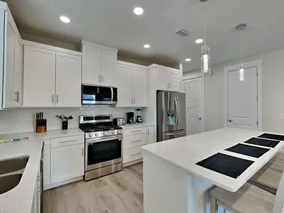 a kitchen with white cabinets and a white counter top at Horizon Dreams in Panama City Beach