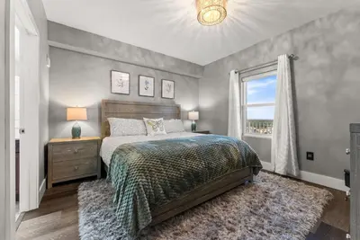 a bedroom with a bed and a window at Luxe Glam 3BD Retreat! Gulf View Family Resort! in Panama City Beach