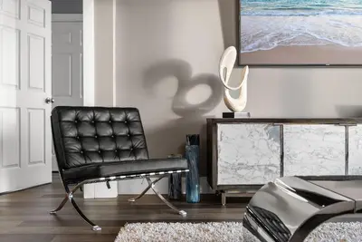 a black chair in a living room with a tv at Luxe Glam 3BD Retreat! Gulf View Family Resort! in Panama City Beach