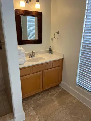 a bathroom with a sink and a mirror at Glory Days 30A - Pool, Bikes & Close Beach Access in Inlet Beach