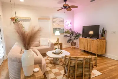 a living room with a couch and a tv at Glory Days 30A - Pool, Bikes & Close Beach Access in Inlet Beach