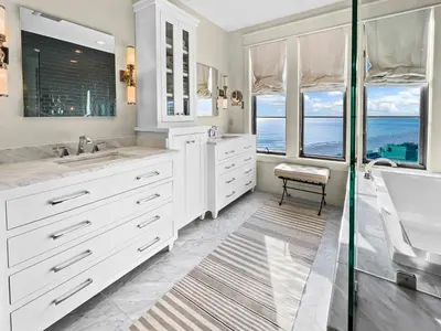 a white bathroom with a tub and a sink at 224 Winston Ln l 4 Bikes Included l Beachfront with Amazing view l Community Pool in Inlet Beach