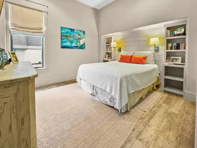 a bedroom with a large bed with orange pillows at 224 Winston Ln l 4 Bikes Included l Beachfront with Amazing view l Community Pool in Inlet Beach