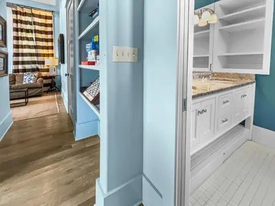 a kitchen with blue walls and white cabinets at 224 Winston Ln l 4 Bikes Included l Beachfront with Amazing view l Community Pool in Inlet Beach