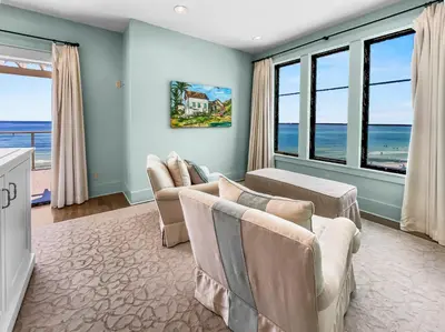 a living room with a couch and chairs and windows at 224 Winston Ln l 4 Bikes Included l Beachfront with Amazing view l Community Pool in Inlet Beach