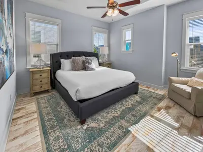 a bedroom with a bed and a couch and a chair at Absolutely Paradise II l Heated 5000 sqft resort style pool l Walk to many restaurants in Santa Rosa Beach