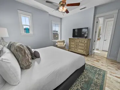 a bedroom with a bed and a ceiling fan at Absolutely Paradise II l Heated 5000 sqft resort style pool l Walk to many restaurants in Santa Rosa Beach