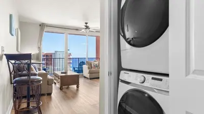 a living room with a microwave and a living room at Beachfront Condo Oceanview Balcony Lagoon Pool Thomas Dr 2308 by AvantStay in Panama City Beach