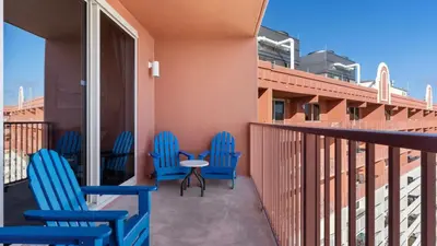 three blue chairs and a table on a balcony at Beachfront Condo Oceanview Balcony Lagoon Pool Thomas Dr 2308 by AvantStay in Panama City Beach