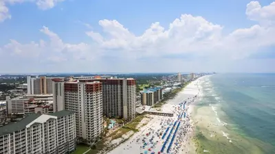 an aerial view of a beach with buildings and the ocean at Beachfront Condo Oceanview Balcony Lagoon Pool Thomas Dr 2308 by AvantStay in Panama City Beach