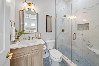 a bathroom with a toilet sink and a shower at Blessings at Pier Park l Luxury l Gulf Front Oasis with Private Pool l Steps From Pier Park in Panama City Beach
