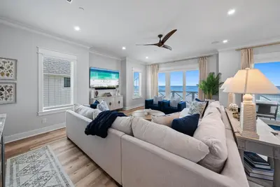 a living room with a couch and a table at Blessings at Pier Park l Luxury l Gulf Front Oasis with Private Pool l Steps From Pier Park in Panama City Beach