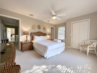 a bedroom with a white bed and a ceiling fan at Blue Palm l Minutes to Sandy White Beach l Bike to Rosemary Beach in Inlet Beach