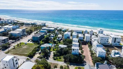 an aerial view of a beach with buildings and the ocean at Blue Palm l Minutes to Sandy White Beach l Bike to Rosemary Beach in Inlet Beach