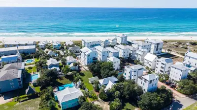 an aerial view of a beach with houses and the ocean at Blue Palm l Minutes to Sandy White Beach l Bike to Rosemary Beach in Inlet Beach