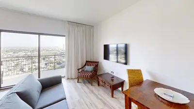 a living room with a couch and a table at Origins at Seahaven 1429 in Panama City Beach