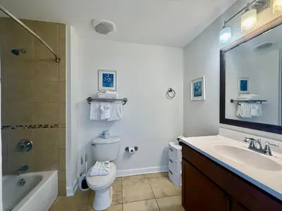 a bathroom with a sink and a toilet and a shower at Origins at Seahaven 1429 in Panama City Beach