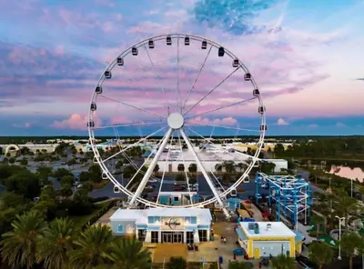 an overhead view of a ferris wheel at a carnival at Origins at Seahaven 709 in Panama City Beach