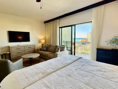 a bedroom with a bed and a view of the ocean at Origins at Seahaven 709 in Panama City Beach