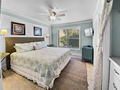 a bedroom with a bed and a window at Commodores 101 l Beachfront l Corner Unit with Pristine Beach Views l Community Pool in Santa Rosa Beach