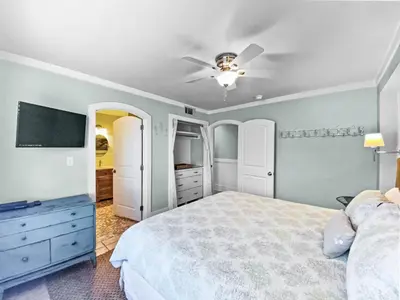 a bedroom with a bed and a ceiling fan at Commodores 101 l Beachfront l Corner Unit with Pristine Beach Views l Community Pool in Santa Rosa Beach