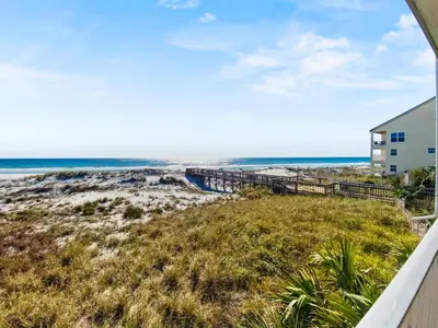 a view of the beach from the balcony of a beach house at Commodores 101 l Beachfront l Corner Unit with Pristine Beach Views l Community Pool in Santa Rosa Beach