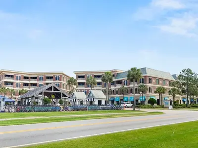 an empty street in front of a large building at Commodores 101 l Beachfront l Corner Unit with Pristine Beach Views l Community Pool in Santa Rosa Beach