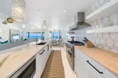 a kitchen with white cabinets and a counter top at Dream On l Beachfront l Golf cart and 4 Bikes Included l Gulf Front Private Pool in Seacrest