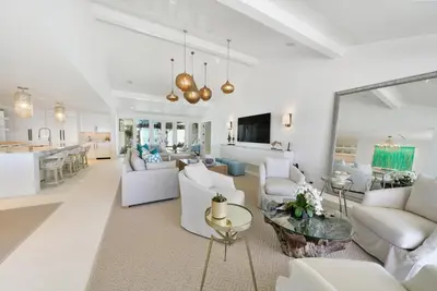 a living room with white furniture and a kitchen at Dream On l Beachfront l Golf cart and 4 Bikes Included l Gulf Front Private Pool in Seacrest