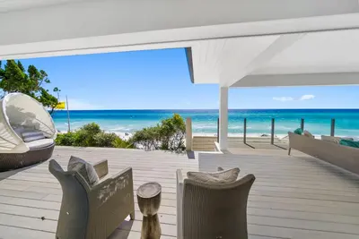 a patio with chairs and a view of the beach at Dream On l Beachfront l Golf cart and 4 Bikes Included l Gulf Front Private Pool in Seacrest