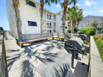 a camera on a bench in front of a building at Eastern Shores 101 l Beachfront l Ground level with direct access to beach and pristine views in Santa Rosa Beach
