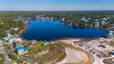 an aerial view of the shoreline of a lake at Eastern Shores 101 l Beachfront l Ground level with direct access to beach and pristine views in Santa Rosa Beach