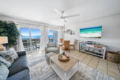 a living room with a couch and a table at Eastern Shores 101 l Beachfront l Ground level with direct access to beach and pristine views in Santa Rosa Beach