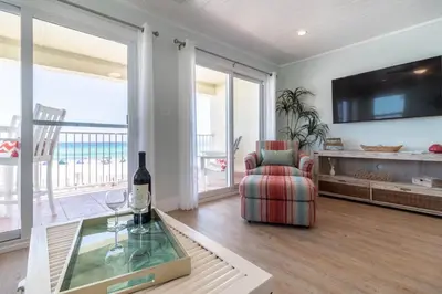 a living room with a couch and a glass table at Eastern Shores 206 l Beachfront l Pristine Beach Views l 2 Bikes included in Santa Rosa Beach