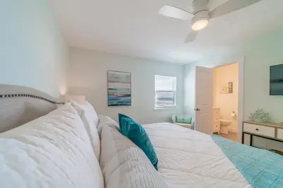 a bedroom with a bed and a ceiling fan at Eastern Shores 206 l Beachfront l Pristine Beach Views l 2 Bikes included in Santa Rosa Beach