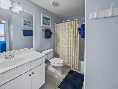 a bathroom with a sink and a toilet and a shower at Emerald Isle l Beachfront l Amazing beach views l Heated Community Pool l Fitness center in Panama City Beach