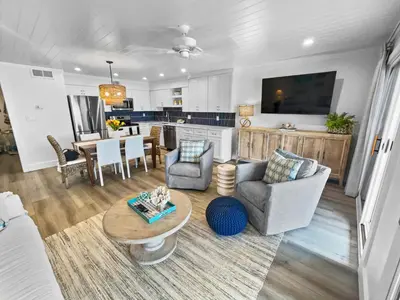 a living room with a couch and a table at Endless Waves 208 l Beachfront l Stunning Beach Views l Bike to Seaside in Santa Rosa Beach