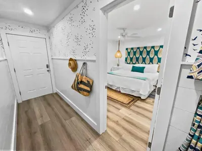 a room with a bed and a door leading to a bedroom at Endless Waves 208 l Beachfront l Stunning Beach Views l Bike to Seaside in Santa Rosa Beach
