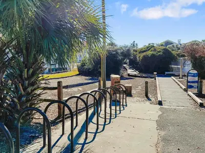 a row of metal barriers next to a palm tree at Hidden Beach Villas 111 l Heated community pool l Tennis and Shuffleboard l Across from the Beach in Santa Rosa Beach