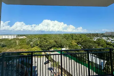 a balcony with a view of a city at Origin at Seahaven 727 in Panama City Beach