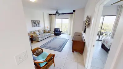 a living room with a couch and a chair at Origin at Seahaven 727 in Panama City Beach