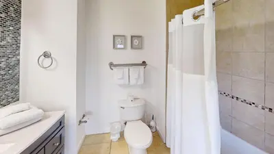 a white bathroom with a toilet and a shower at Origin at Seahaven 727 in Panama City Beach