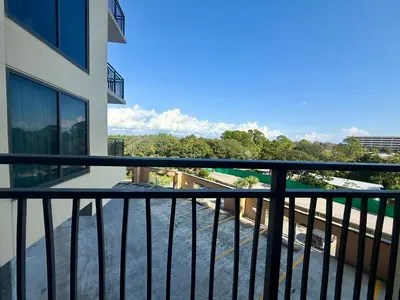 a balcony with a view of a building at Origin at Seahaven 423 in Panama City Beach