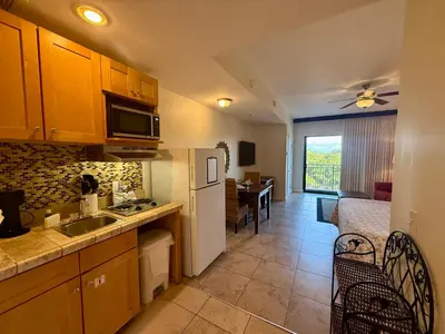 a kitchen with a white refrigerator and a dining room at Origin at Seahaven 423 in Panama City Beach