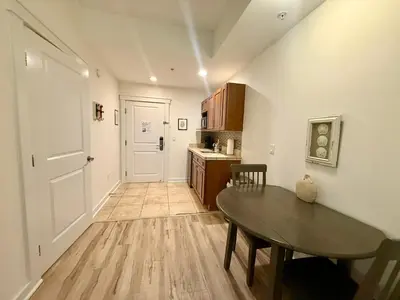 a kitchen with a table and a dining room at Origin at Seahaven 402 in Panama City Beach