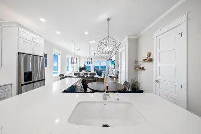 a kitchen with a white counter and a sink at Joy by the Sea l Private heatable pool l Beach Front l Family Activities nearby in Panama City Beach