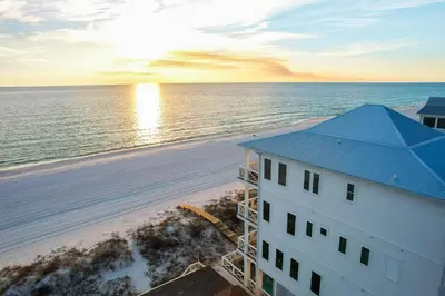 an aerial view of a building and the beach at Joy by the Sea l Private heatable pool l Beach Front l Family Activities nearby in Panama City Beach