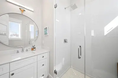 a bathroom with a shower and a sink and a mirror at Joy by the Sea l Private heatable pool l Beach Front l Family Activities nearby in Panama City Beach