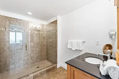 a bathroom with a shower and a sink at Sterling Breeze 307 by Emerald Coast Retreats in Panama City Beach