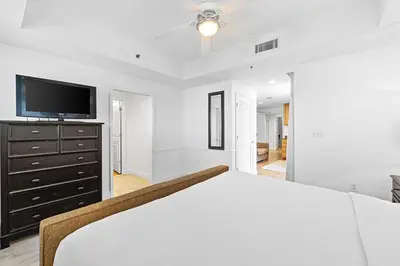 a bedroom with a bed and a flat screen tv at Sterling Breeze 307 by Emerald Coast Retreats in Panama City Beach